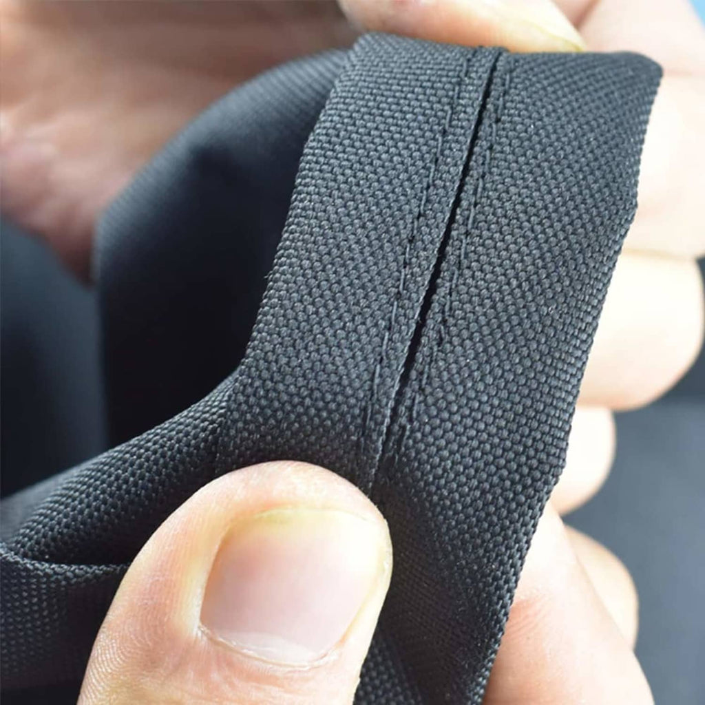 Close-up of black grill cover edge with reinforced stitched seam and durable fabric