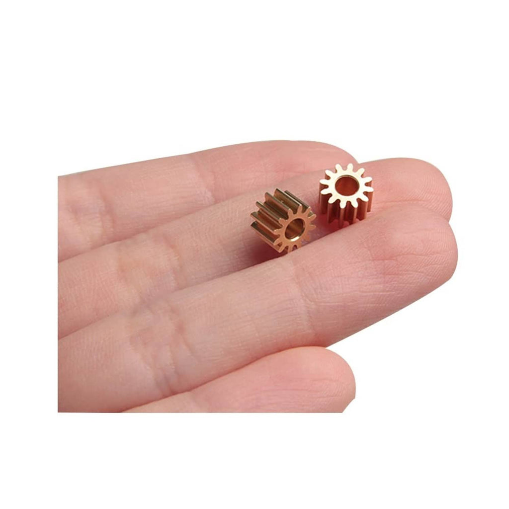 Small copper spur gear with 12 teeth, 3 mm bore, held in fingers