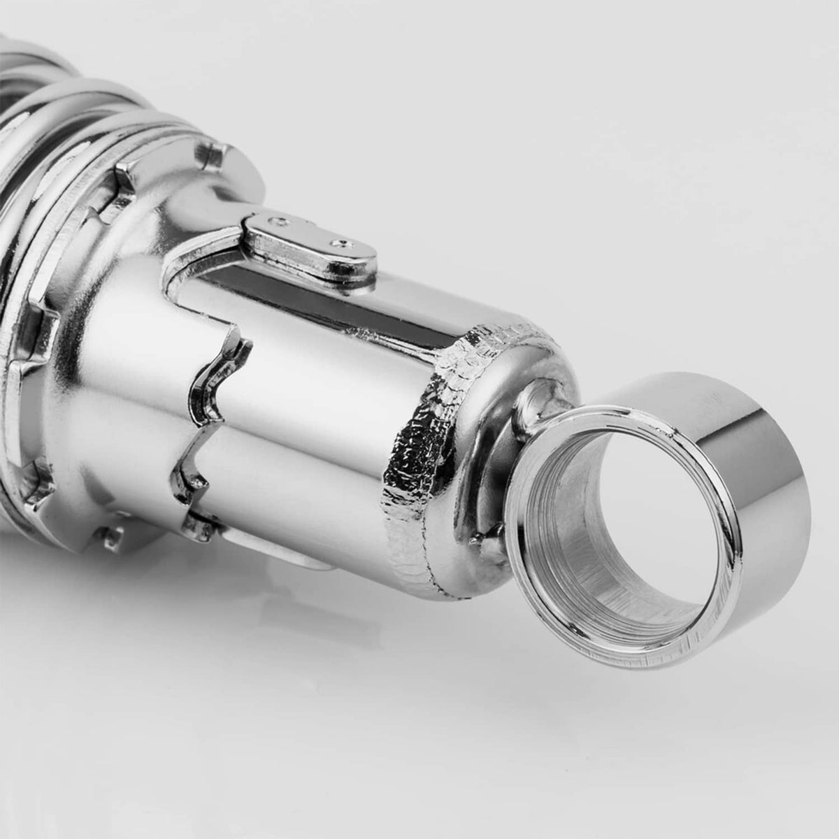 Close-up of a chrome shock end cap, mounting collar, and threaded hardware