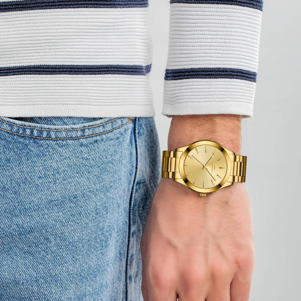 Gold stainless steel men’s wristwatch on denim sleeve with round dial