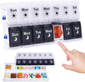 Weekly pill organizer with clear lid, black day compartments, and one open section with pills