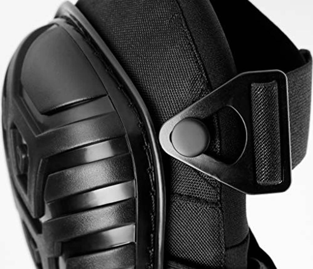 Black knee pad close-up showing molded shell with textured fabric strap attachment