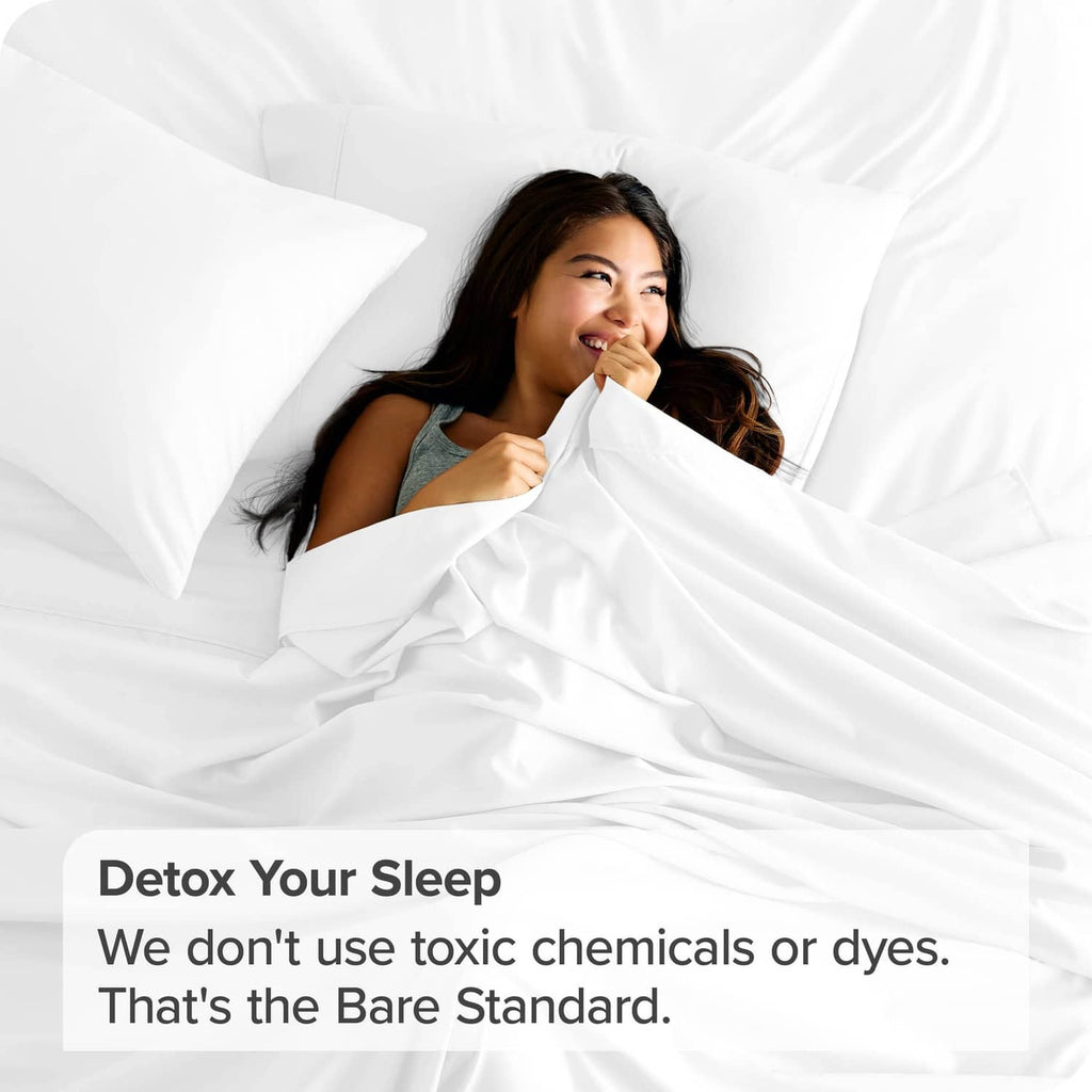 White microfiber flat sheet on bed, smooth drape with gathered folds