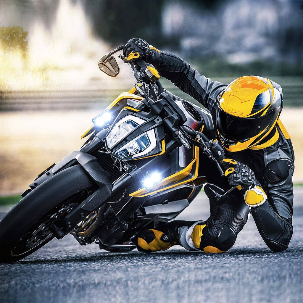 Motorcycle with two 3-inch LED pod lights mounted on the front, glowing bright