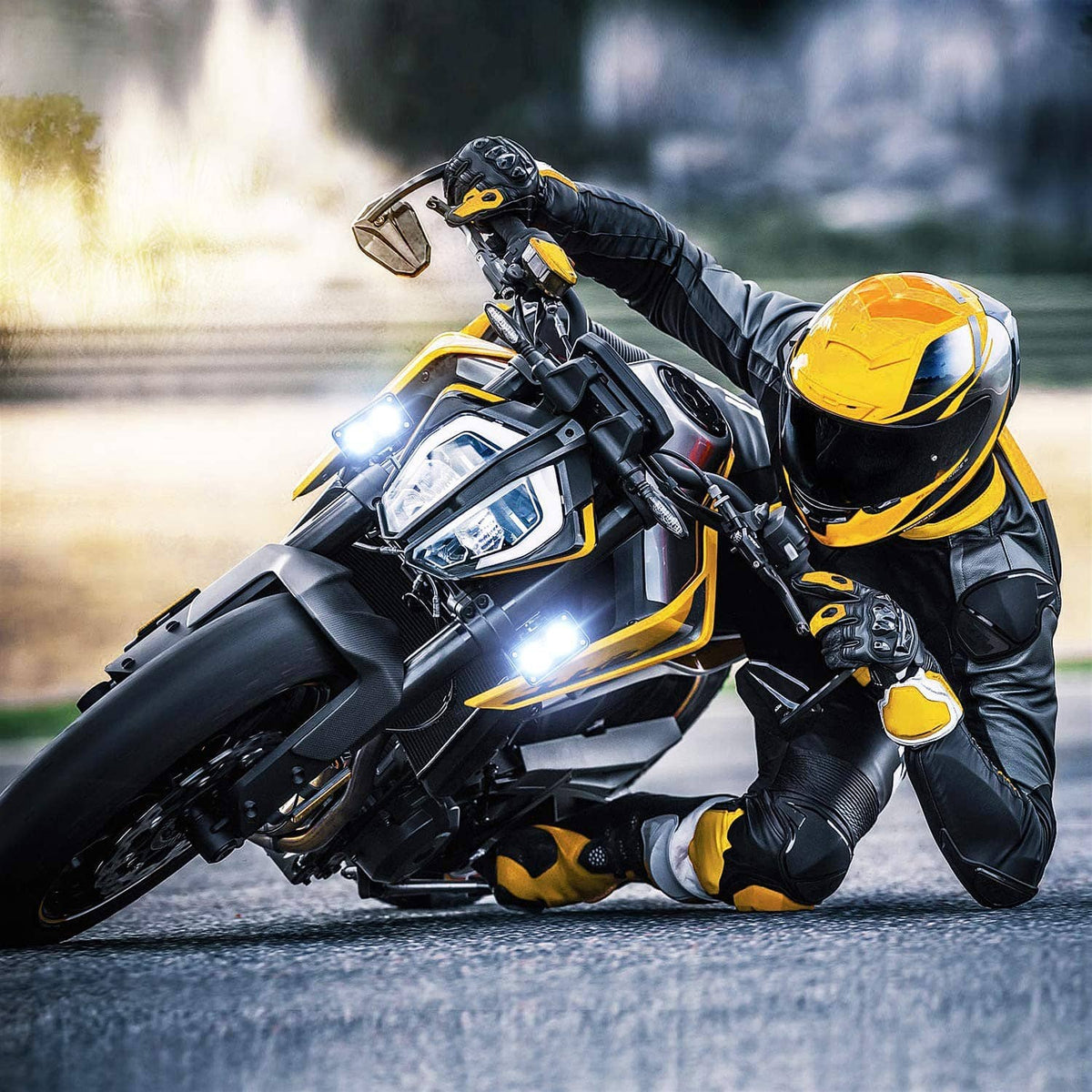 Motorcycle with two 3-inch LED pod lights mounted on the front, glowing bright