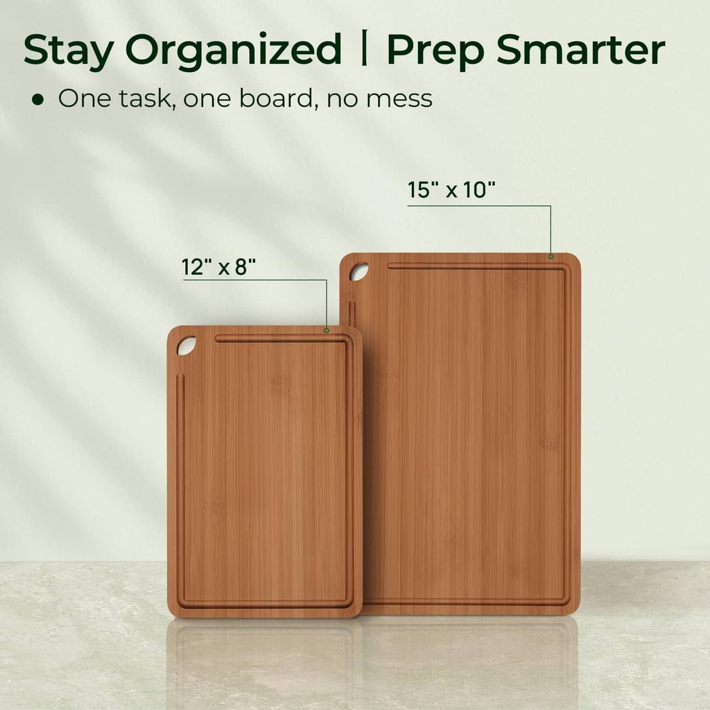 Set of two brown bamboo cutting boards, large and small with corner hand holes