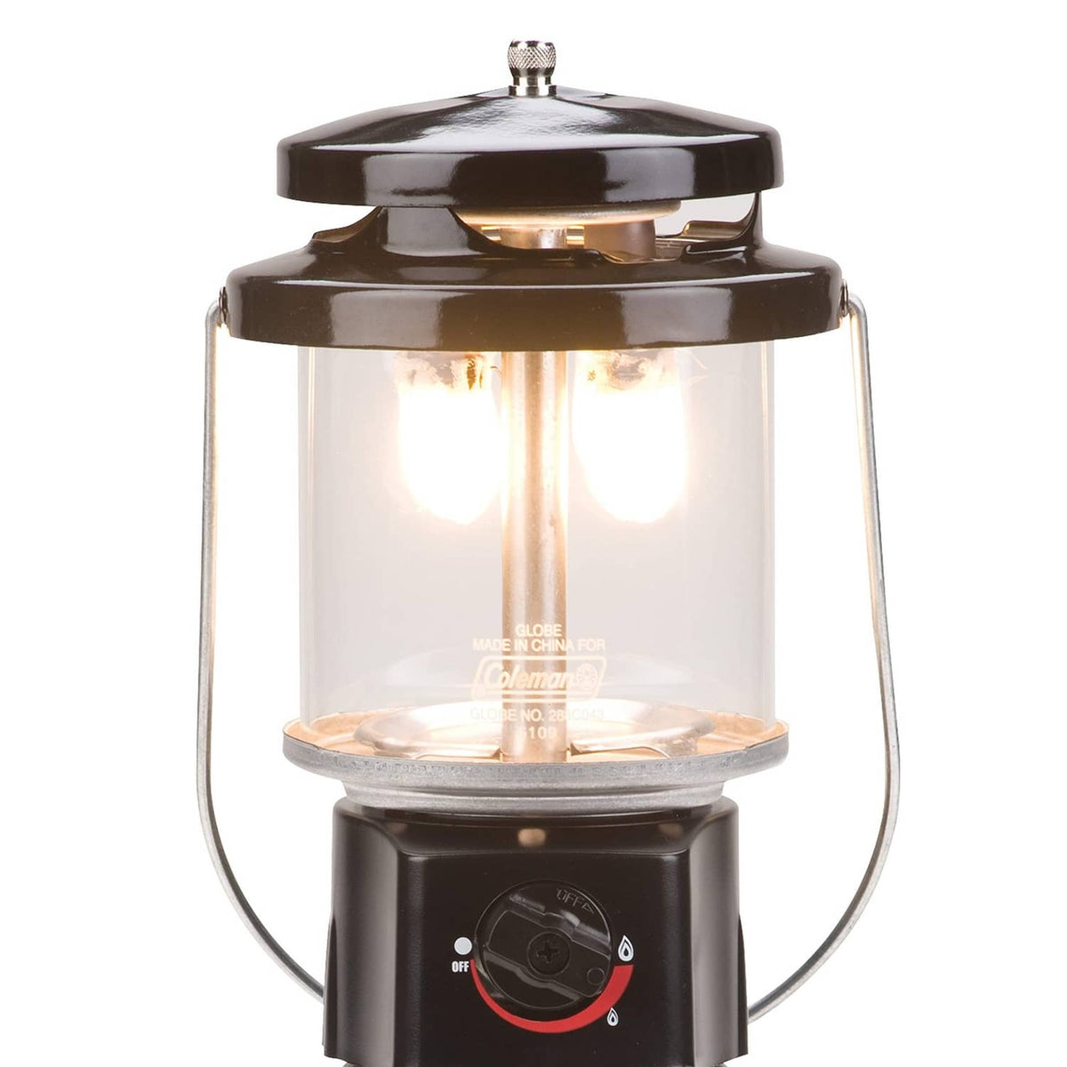 Coleman propane lantern with lit burner, clear glass housing, and metal top