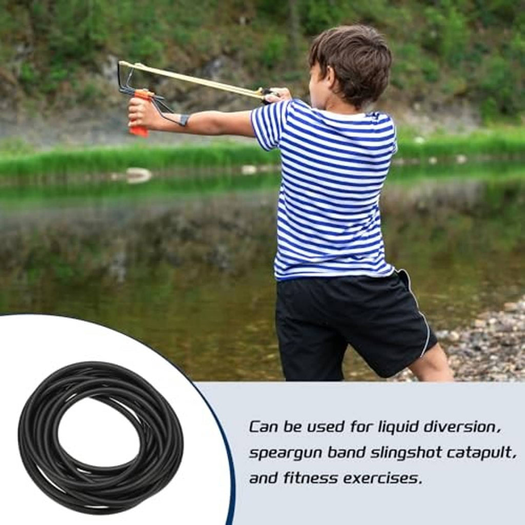 Black rubber tubing coil with kid using a slingshot-style band outdoors