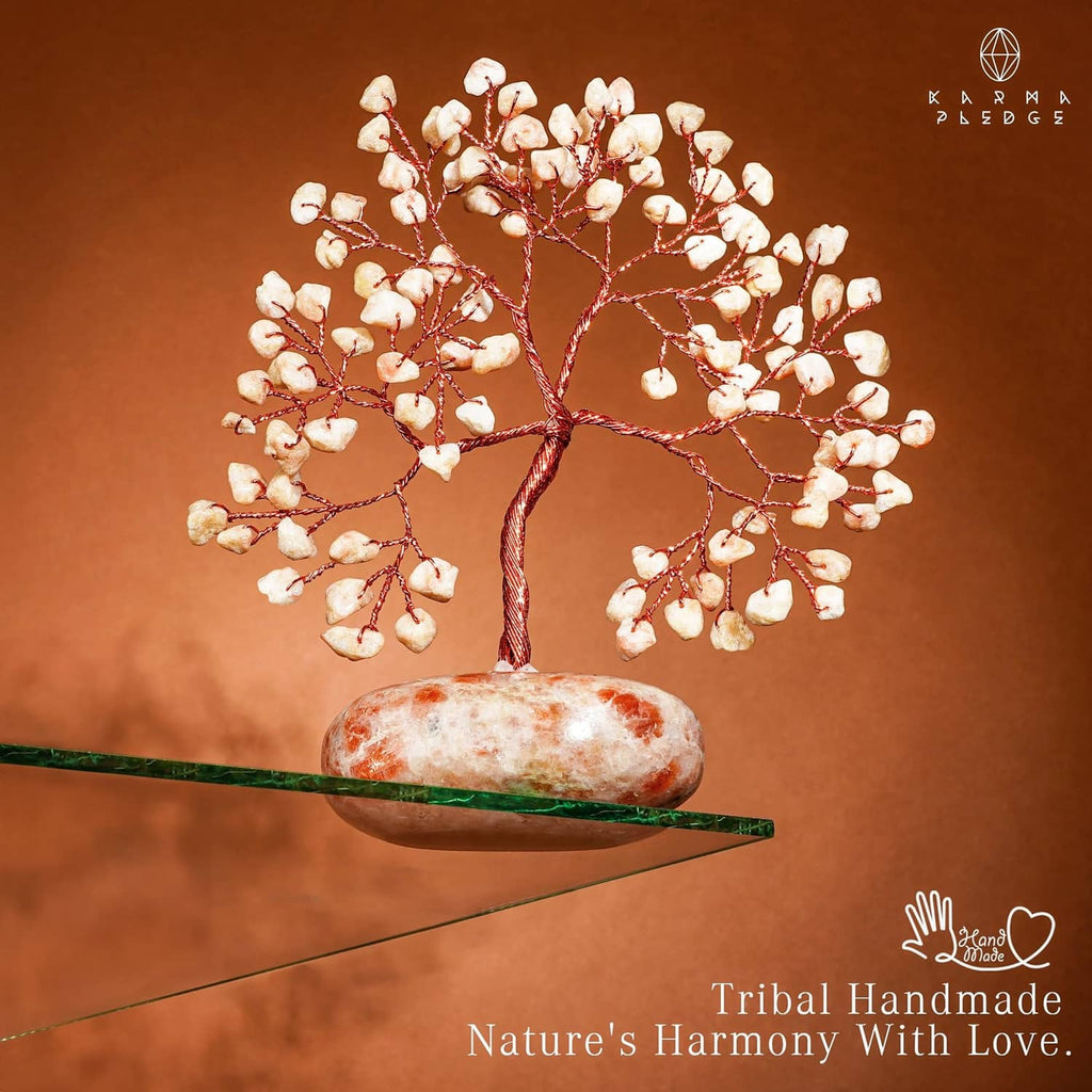 Sunstone crystal tree ornament with red wire canopy and orange-pink oval stone base
