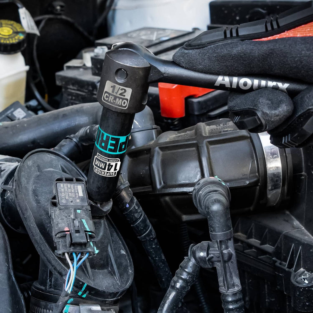 1/2-inch drive impact socket attached to ratchet in an automotive engine bay