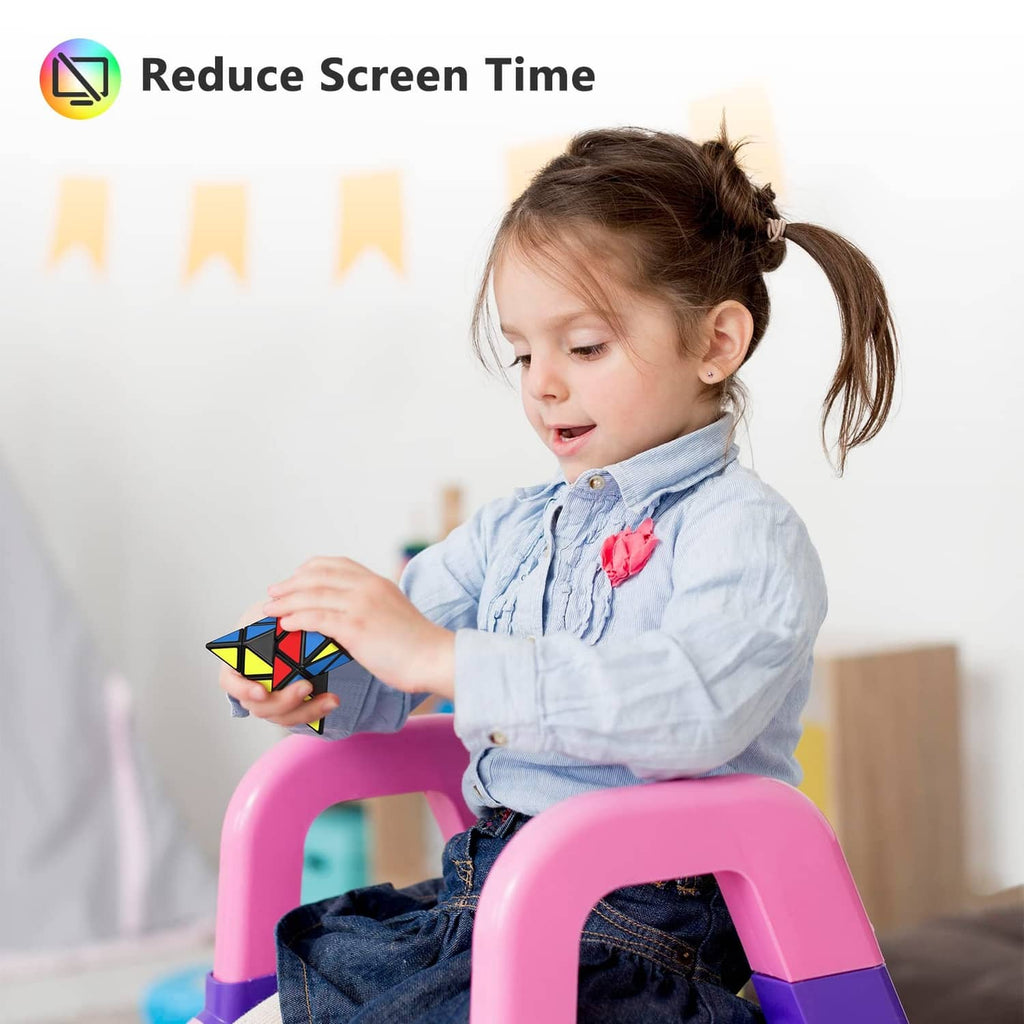 Young child holding a multicolor speed cube while seated on a pink chair