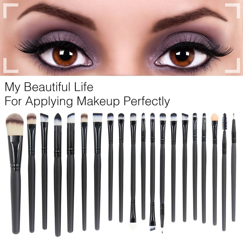 Set of makeup brushes on face backdrop; black handles with soft bristle heads