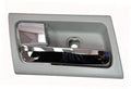 Gray interior door handle with chrome lever, rectangular bezel