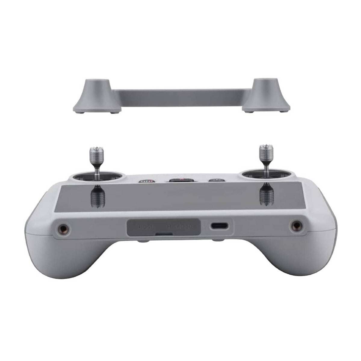 Grey remote controller with joystick protector caps installed on top