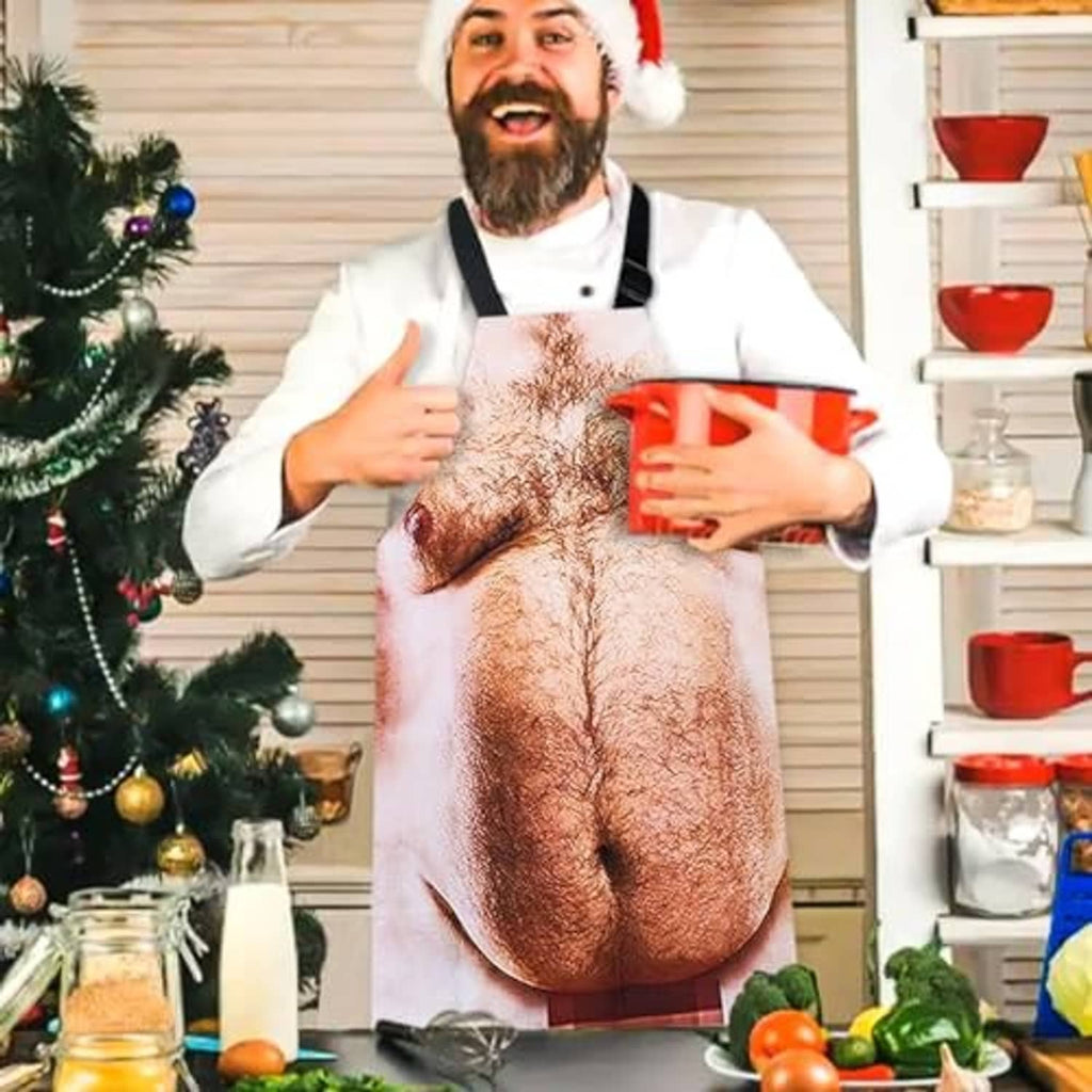 Funny novelty grilling apron worn indoors with holiday chef hat, printed male torso design