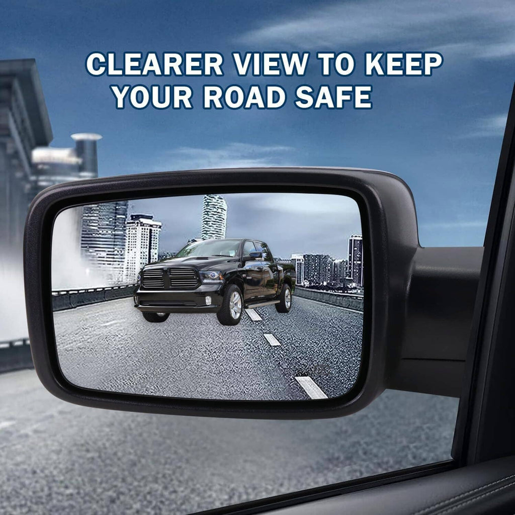 Black side mirror on vehicle door, reflecting road view with wet streaks