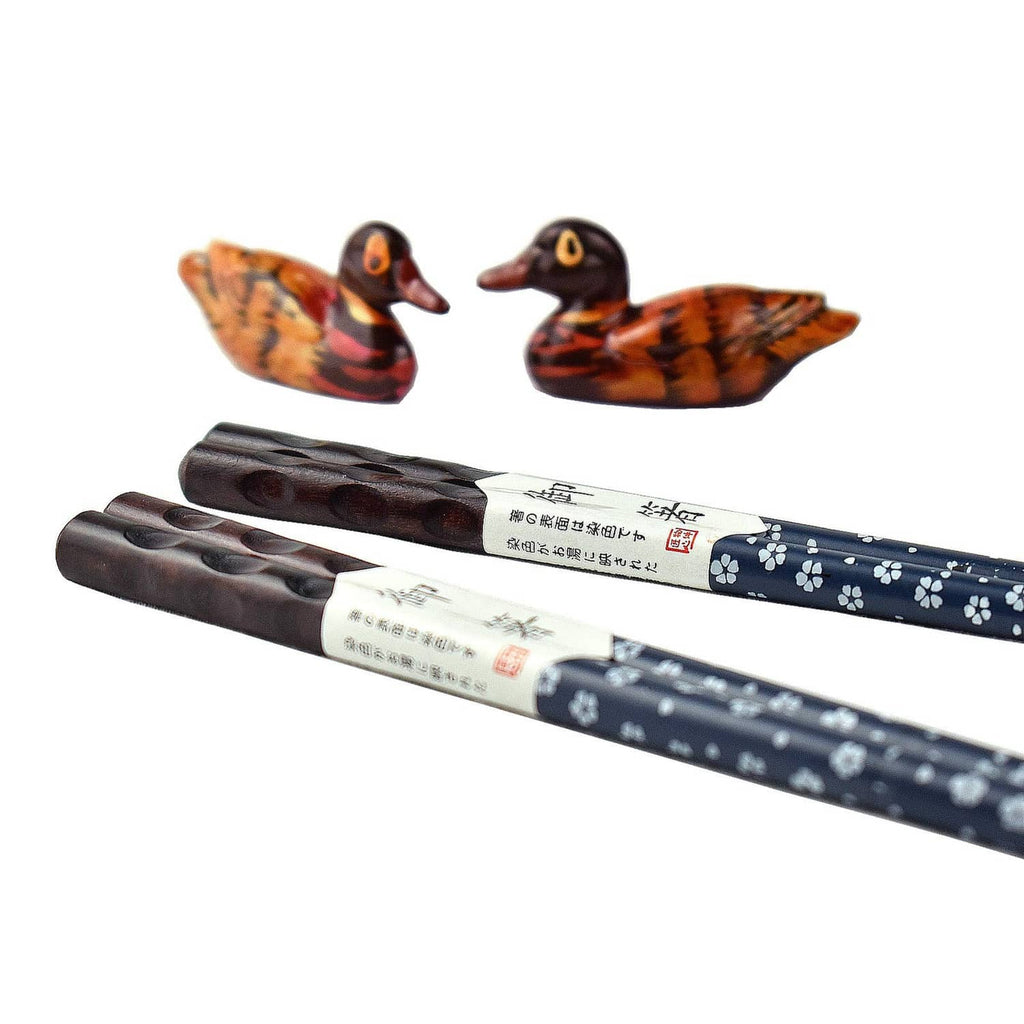 Duck-shaped chopstick rests and blue patterned chopsticks with carrying ends