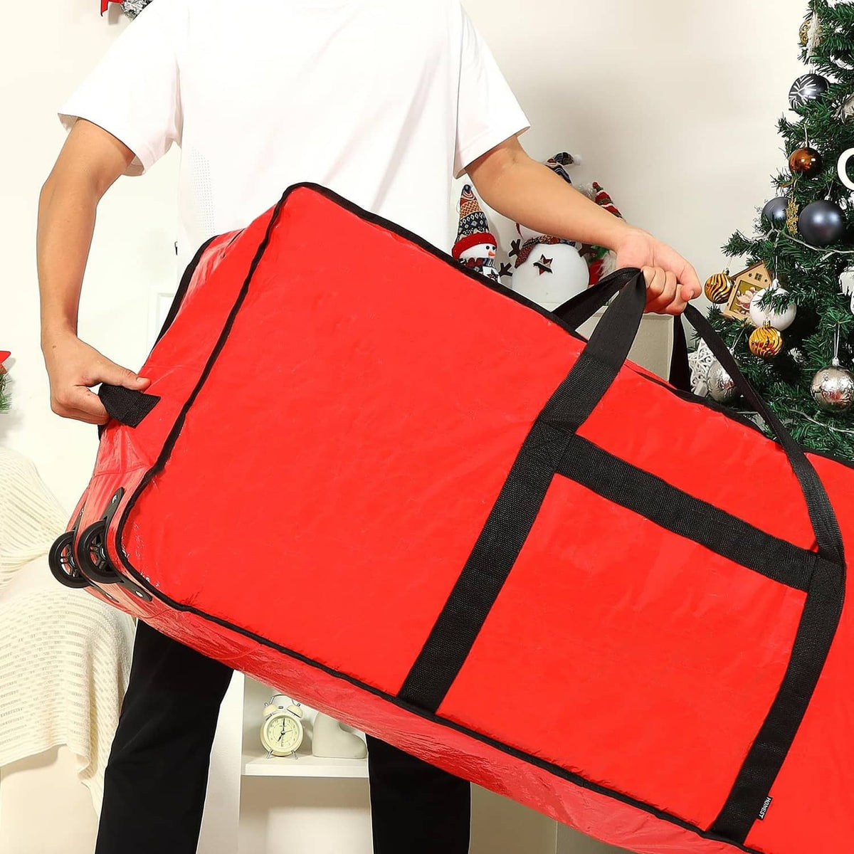 Red Christmas tree storage bag on wheels with black straps and handles