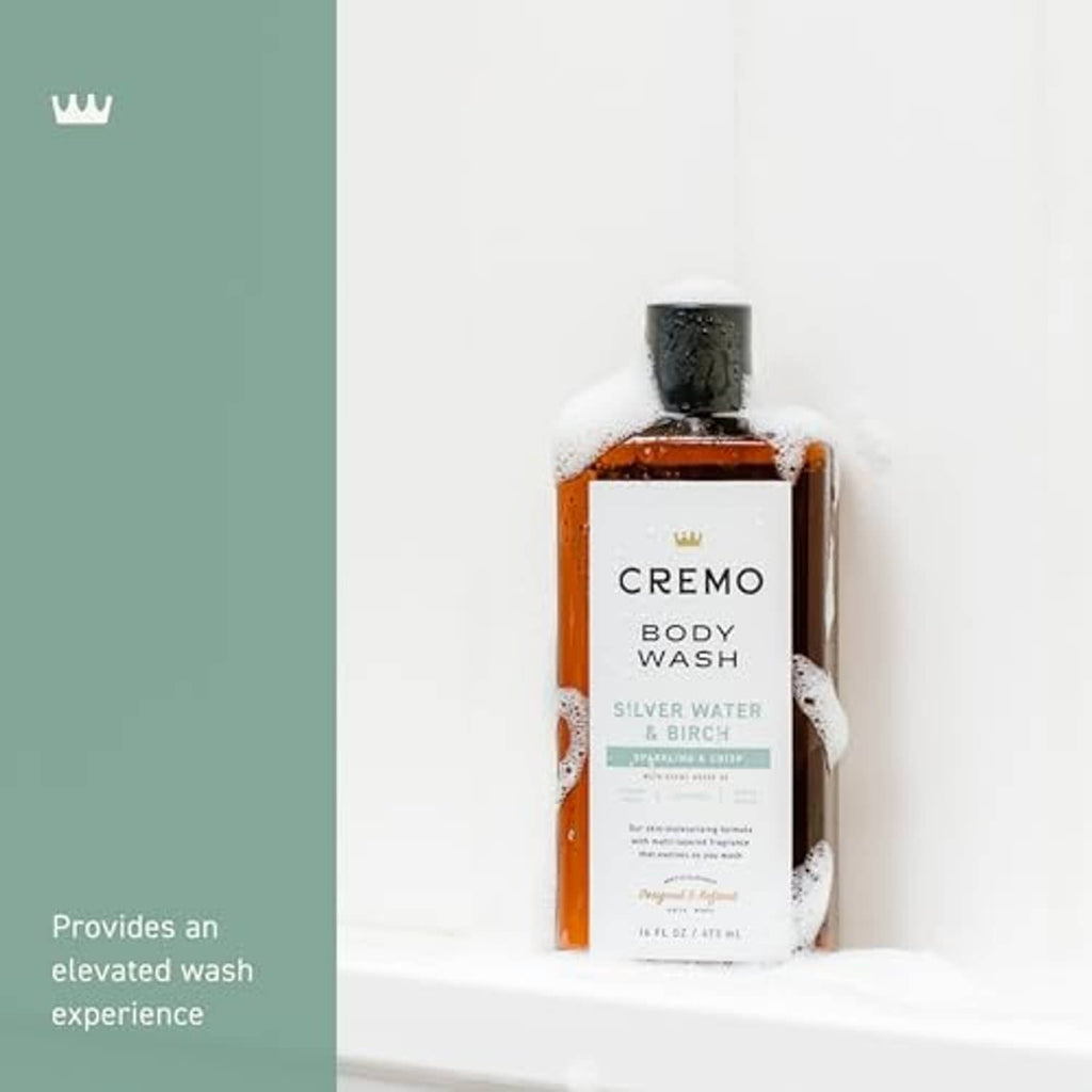 Cremo body wash bottle with Silver Water & Birch label under foam, black cap