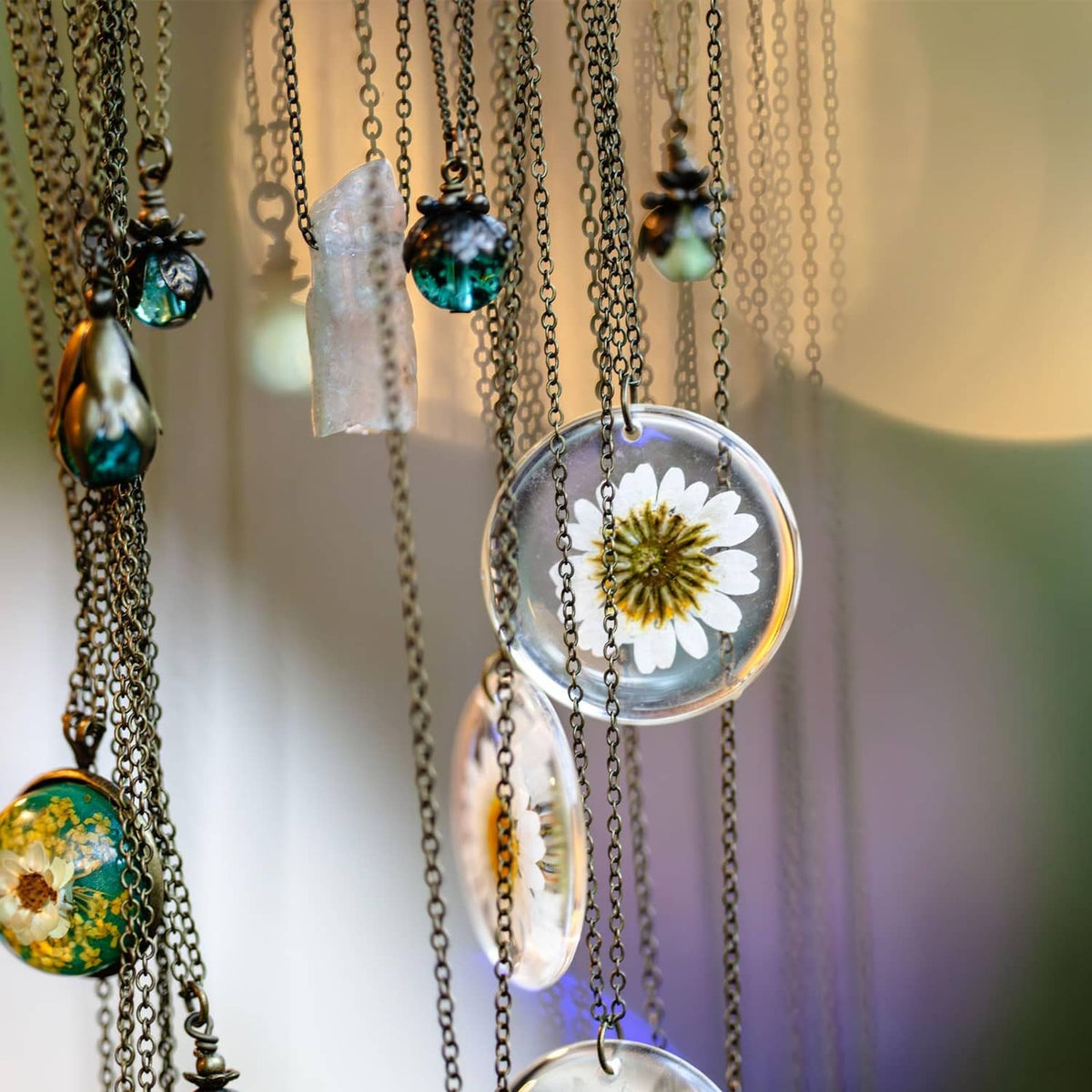 Silver-tone necklace with round domed crystal lens pendants and floral details