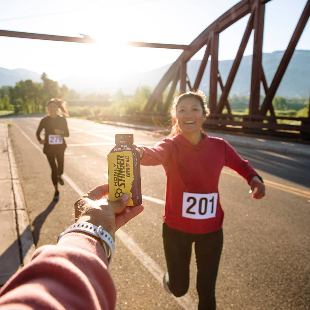Acai pomegranate energy gel pouch held up during a run