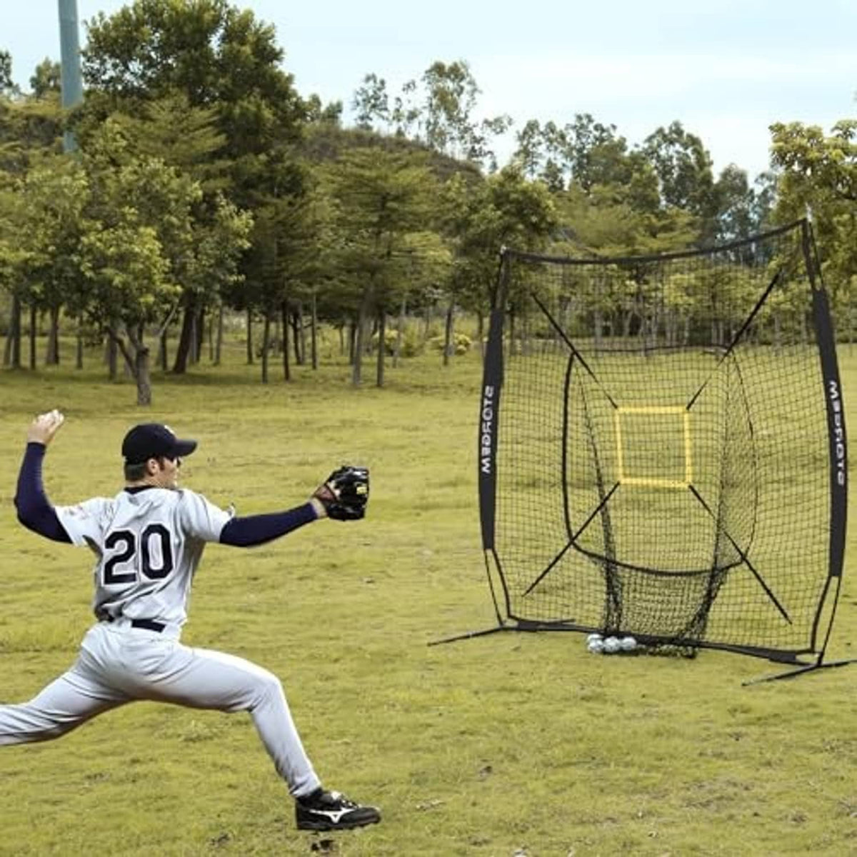 Black practice net with yellow strike-zone square and mesh frame during outdoor batting