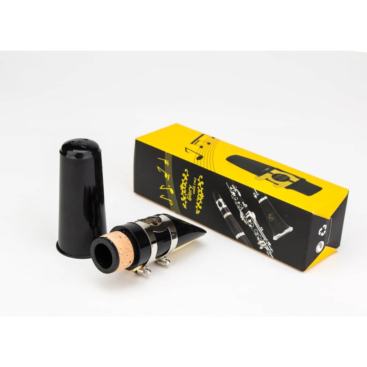 Clarinet mouthpiece kit with black mouthpiece, cork reed, and yellow presentation box