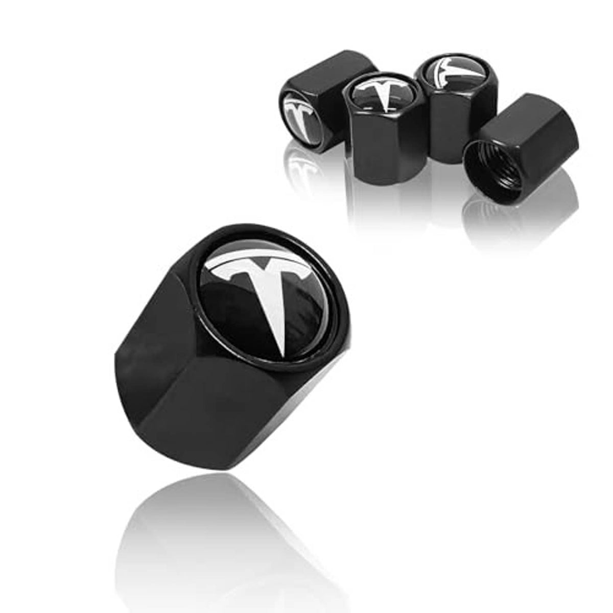 Set of black tire valve stem caps with white logo and textured metal exterior