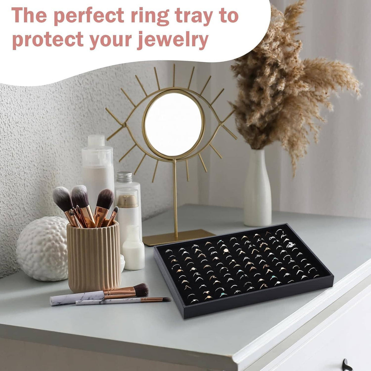 Black velvet-lined ring holder tray with ring slots, displayed on a tabletop
