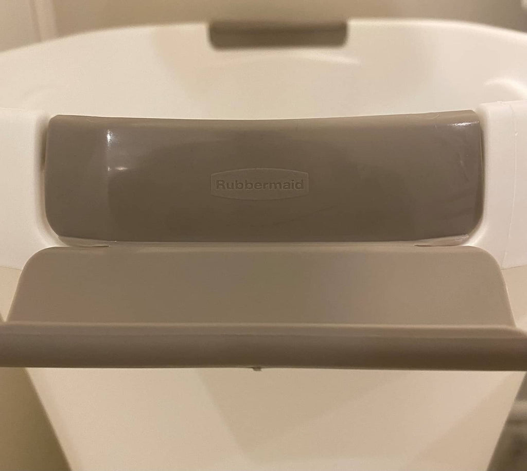 Close-up of gray lid with Rubbermaid logo on white open-top trash can