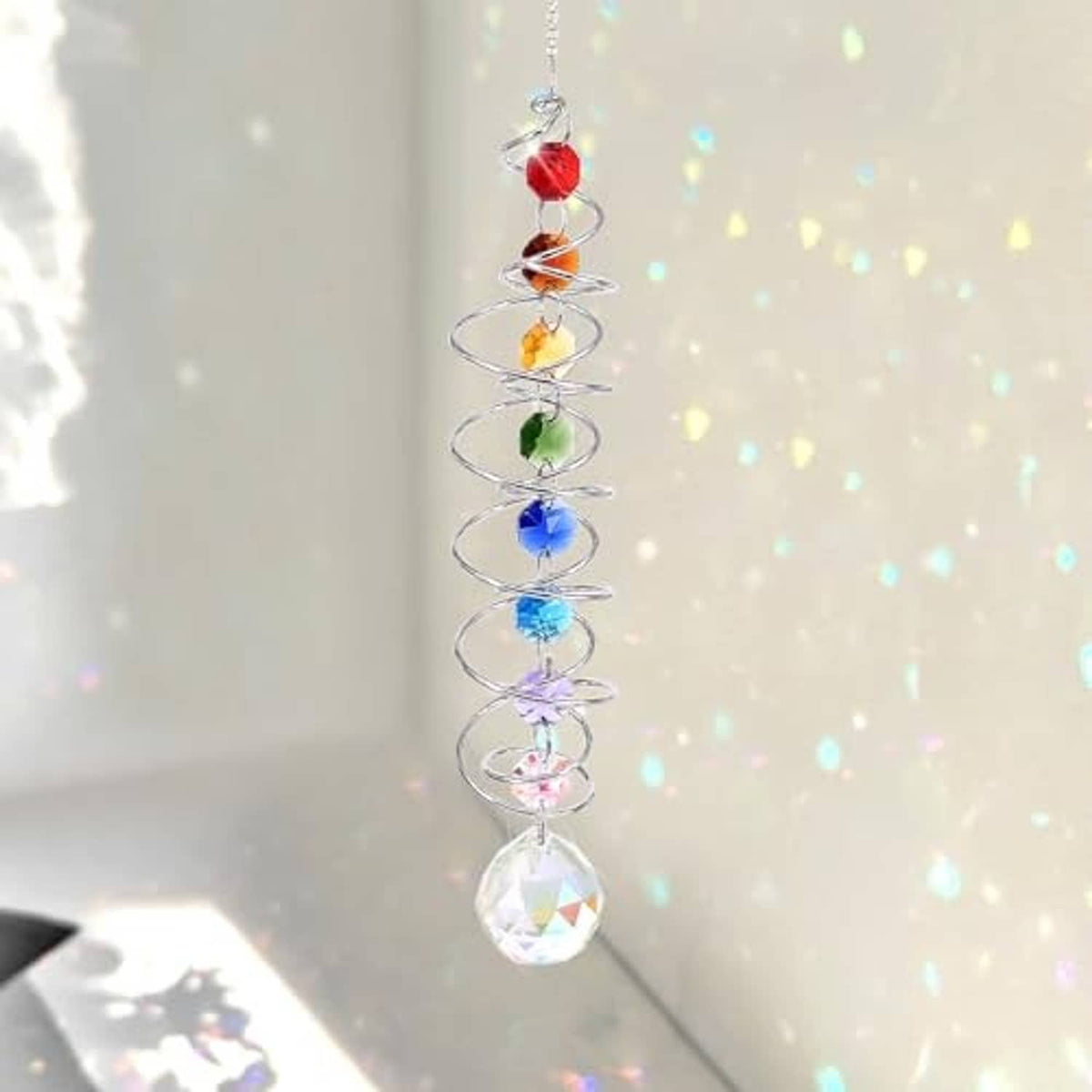 Hanging crystal wind spinner with spiral coil, multicolor beads, and a faceted prism ball charm.