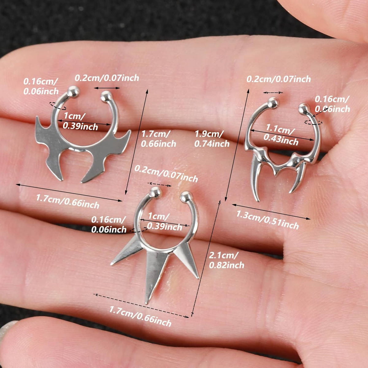 Silver spiked non-piercing faux septum rings set, size comparison on hand