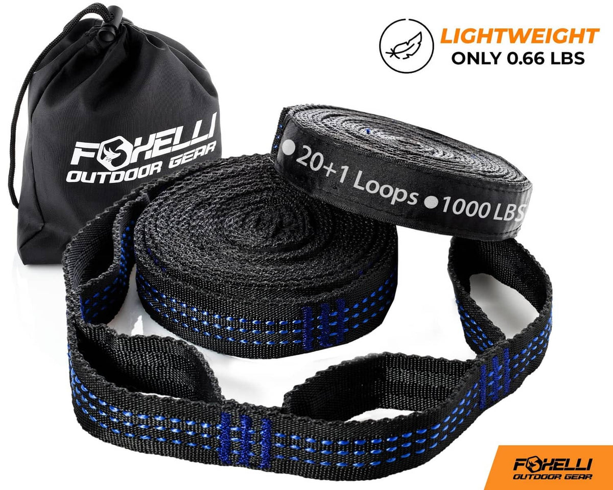 Rolled extra-long hammock straps in black and blue webbing, with loop and weight label