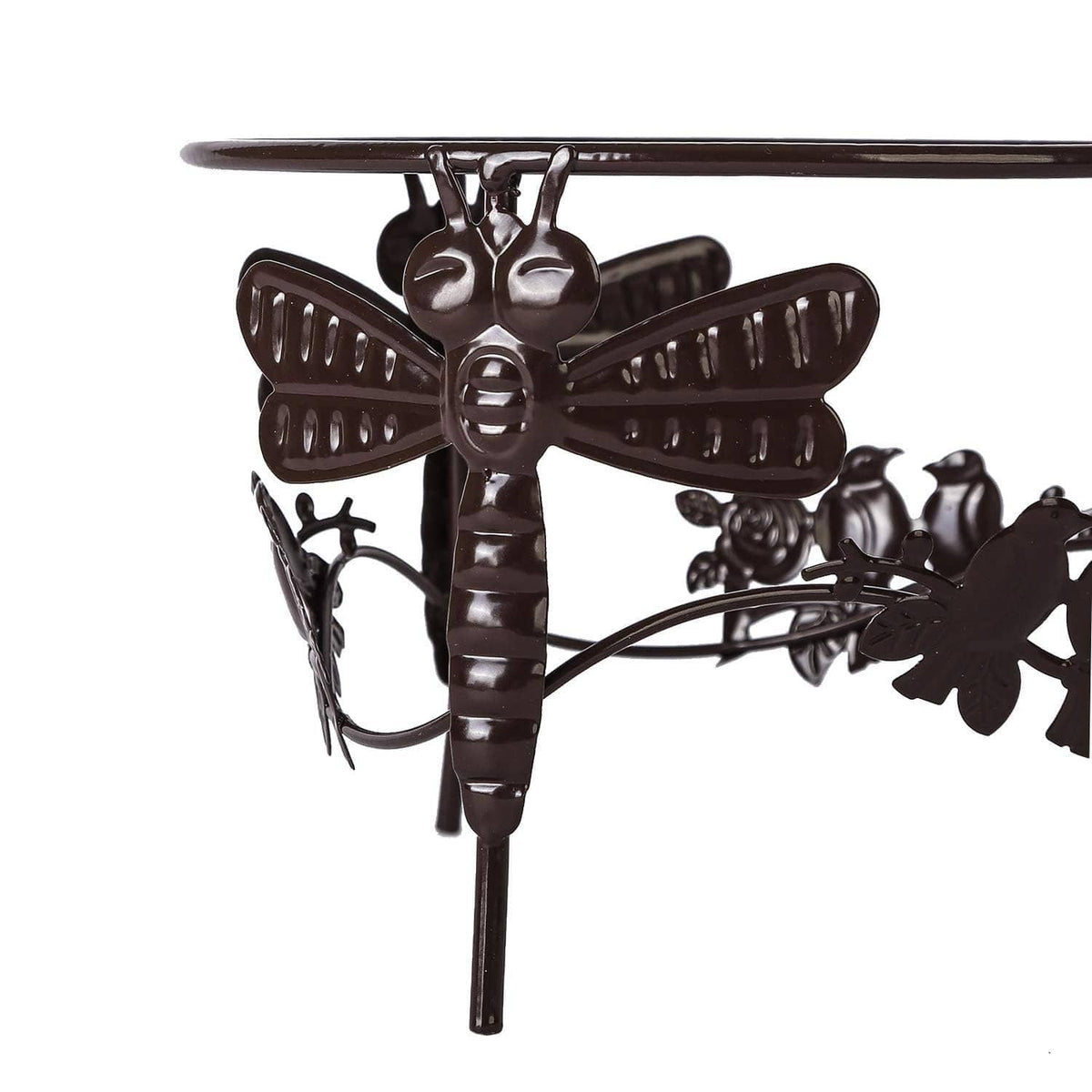 Metal gazing ball stand detail with winged dragonfly crossbar and leaf cutouts.