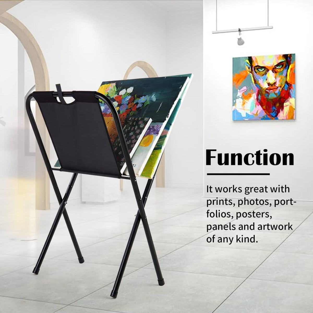Black canvas print rack holding colorful artwork on an angled stand