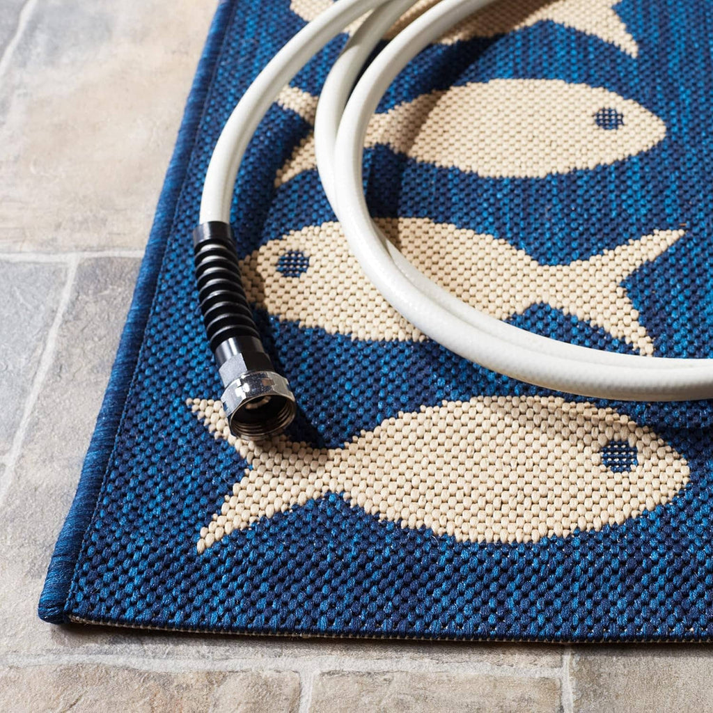 Navy rug corner with beige fish pattern and visible woven texture.