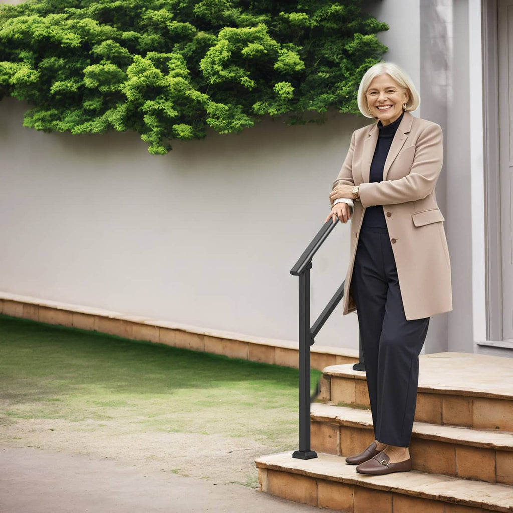 Black outdoor stair handrail on concrete steps beside a home entrance