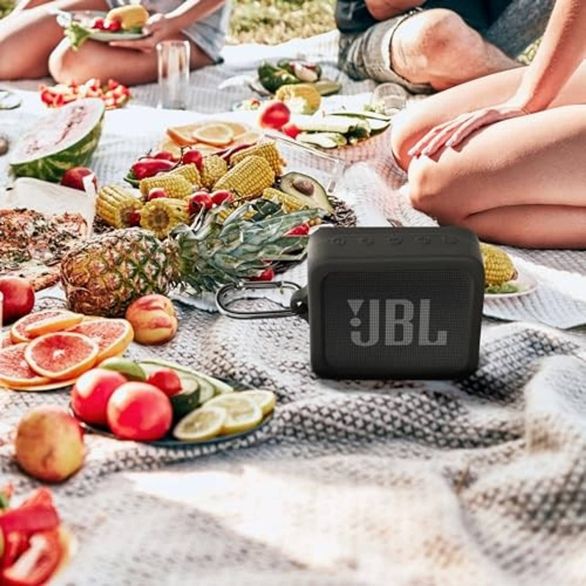 Black silicone protective case on a mini portable speaker during outdoor use