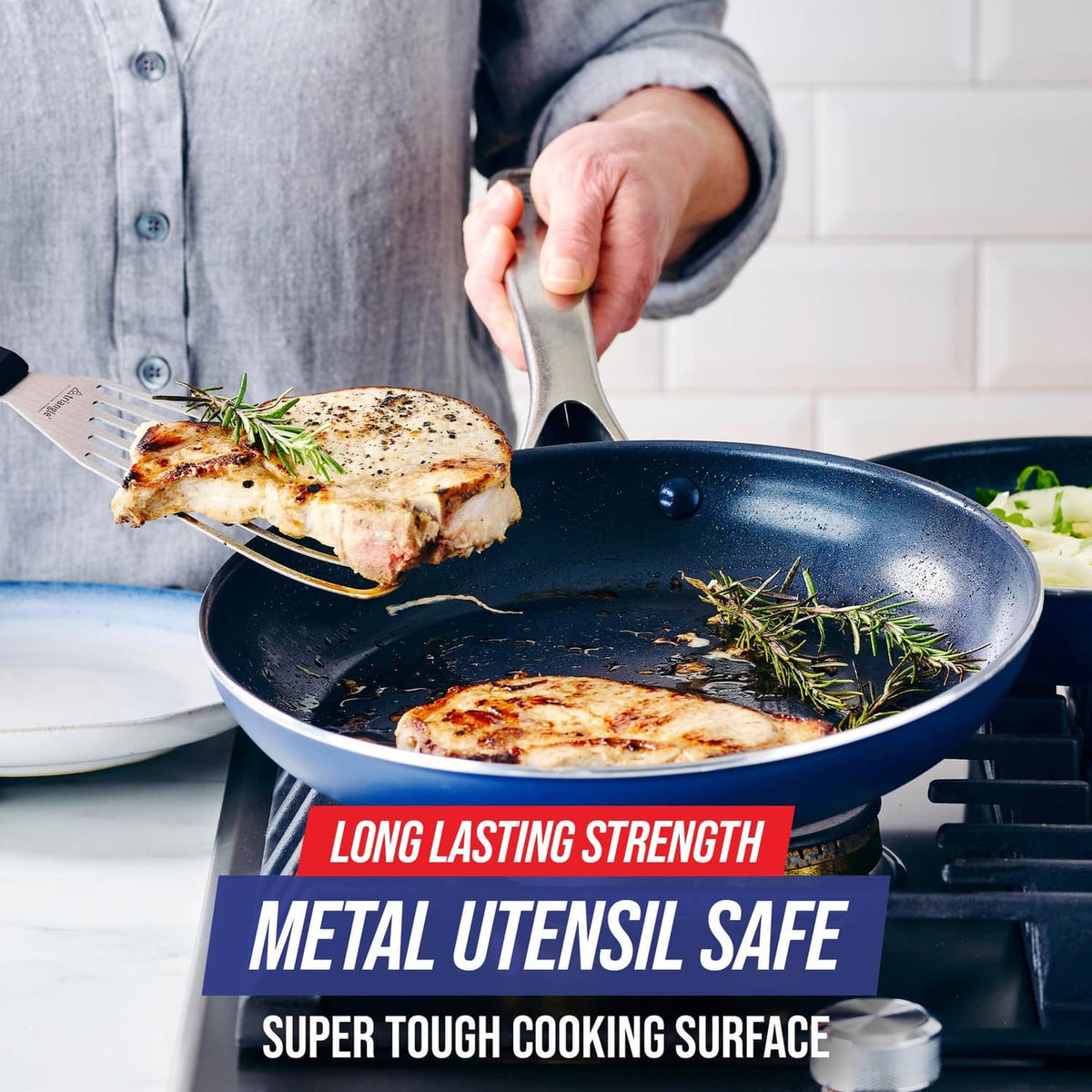 Blue nonstick frying pan skillet with browned chicken and herbs on speckled surface