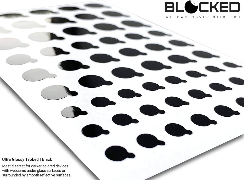 Black glossy tabbed webcam cover stickers with scattered oval shapes across a sheet
