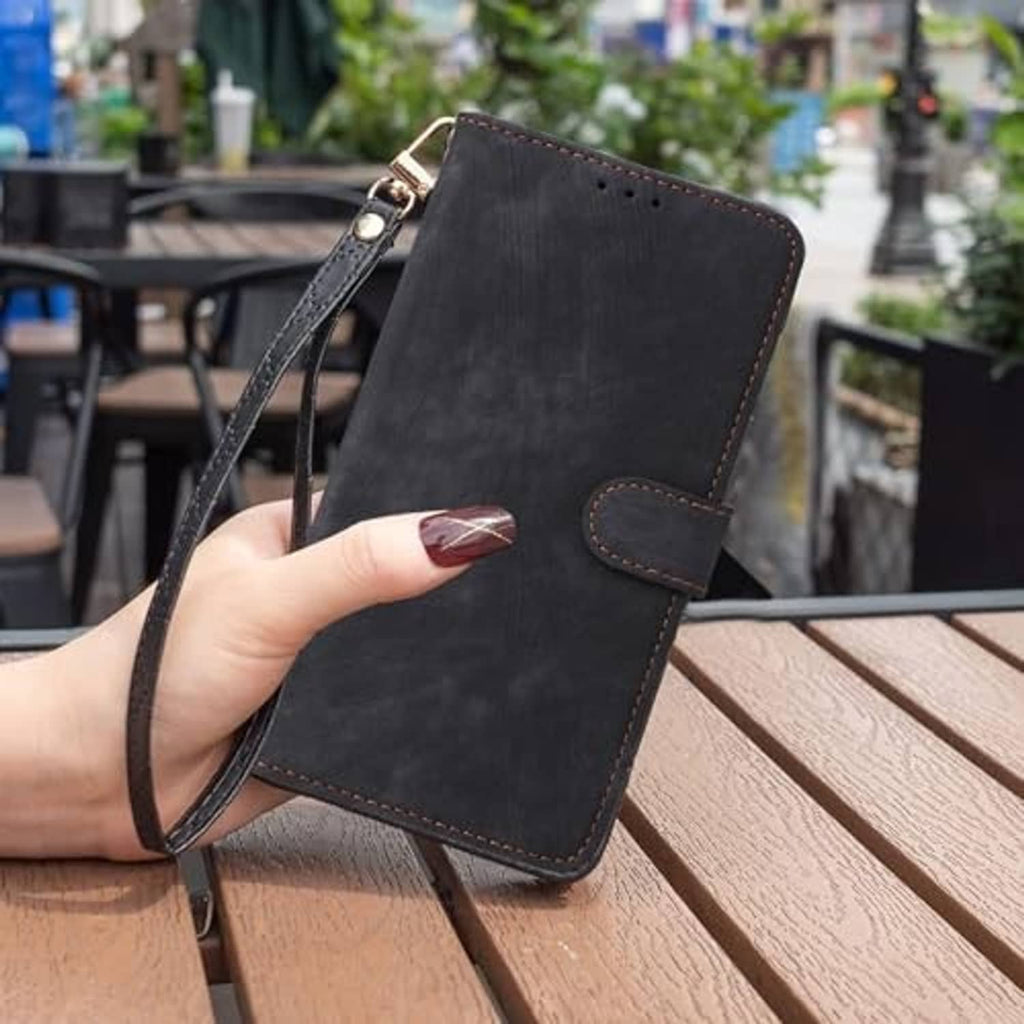 Black wallet folio phone case with wrist strap and stitched front flap.