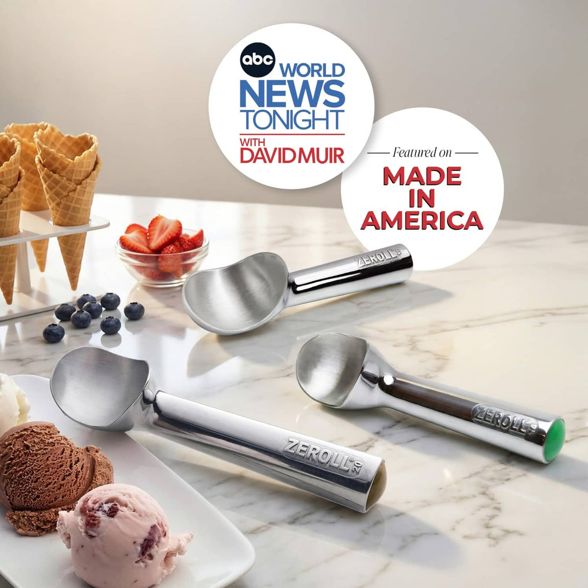 Assorted Zeroll ice cream scoops on tray, stainless metal bowls and embossed handles.