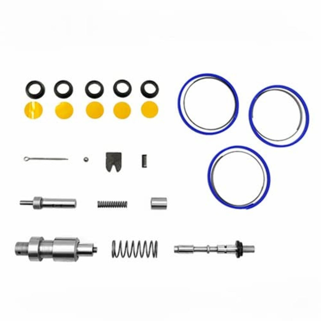 Transmission shift repair kit parts laid out: black seals, yellow discs, blue O-rings, springs