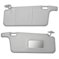 Gray interior sun visor pair with vanity mirror cutouts and mounting hardware