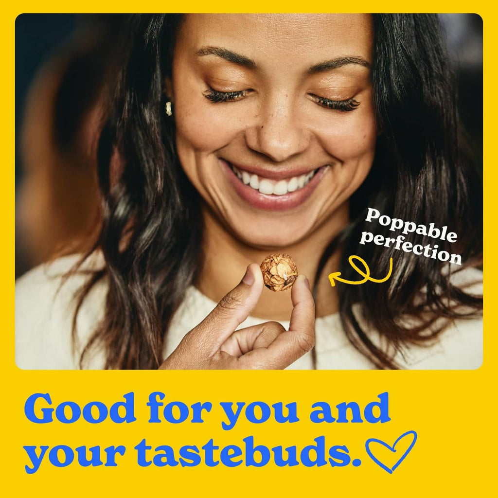 Smiling woman holding a chocolate chip granola mini cookie