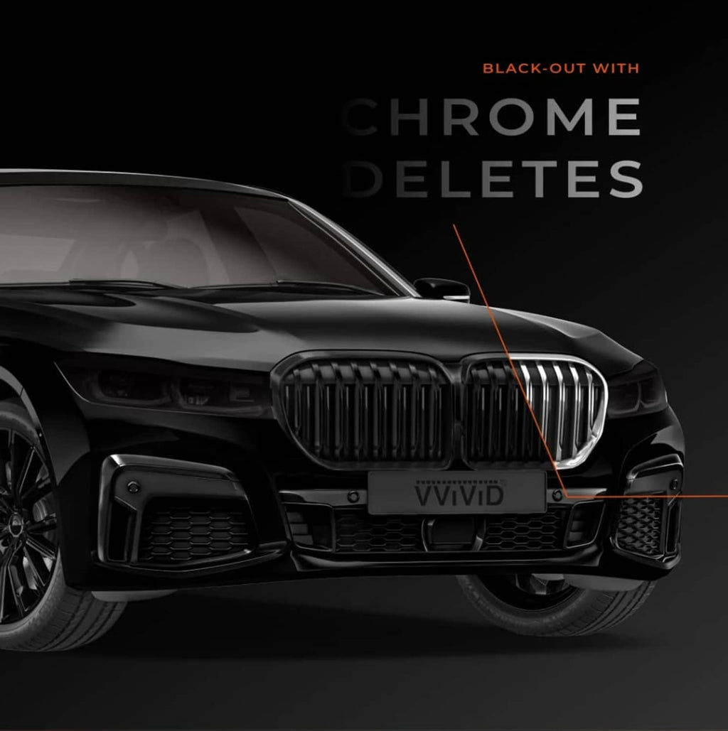 Matte black vinyl tape applied on a car front grille area, with orange guide line