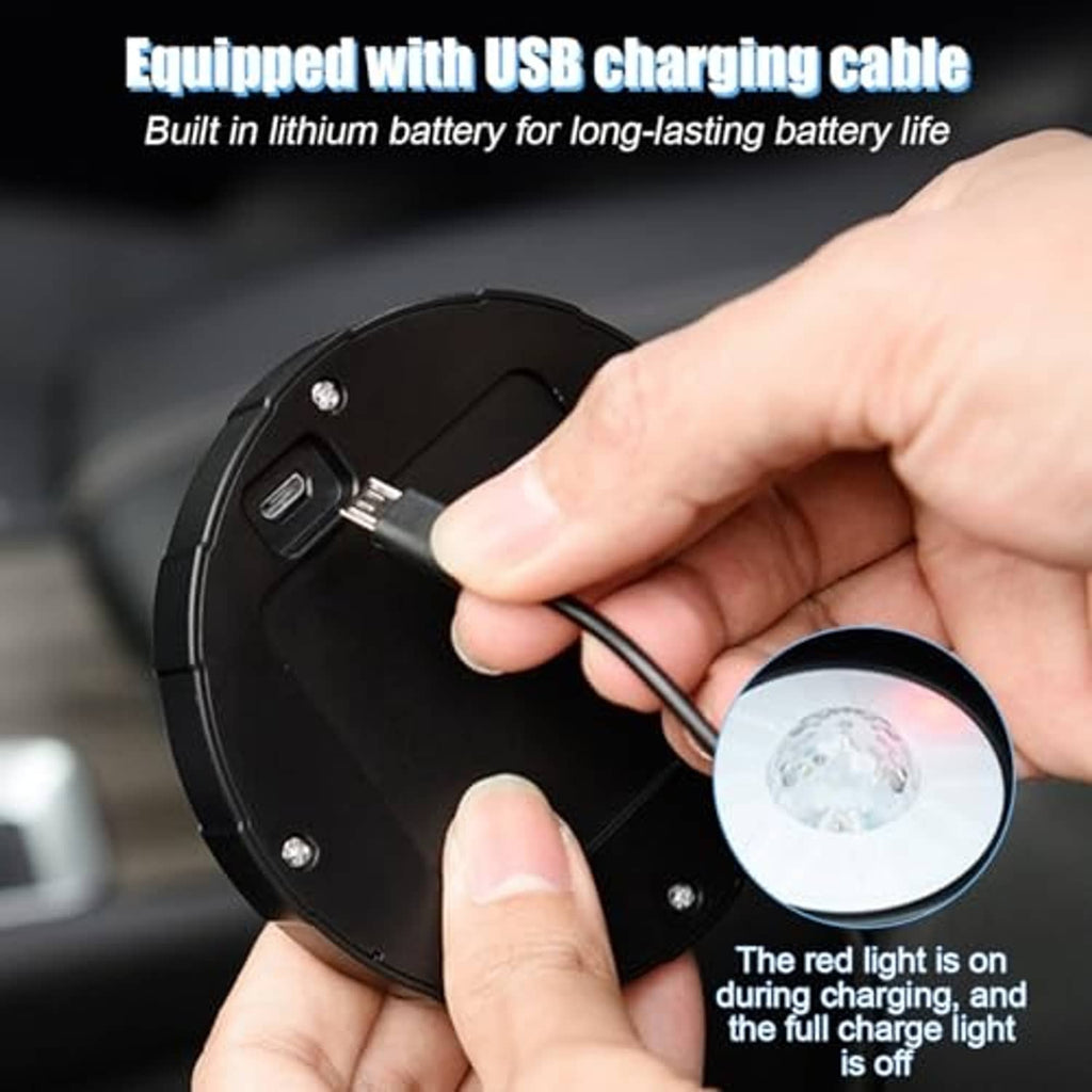 Round magnetic LED light being charged with USB cable, close-up