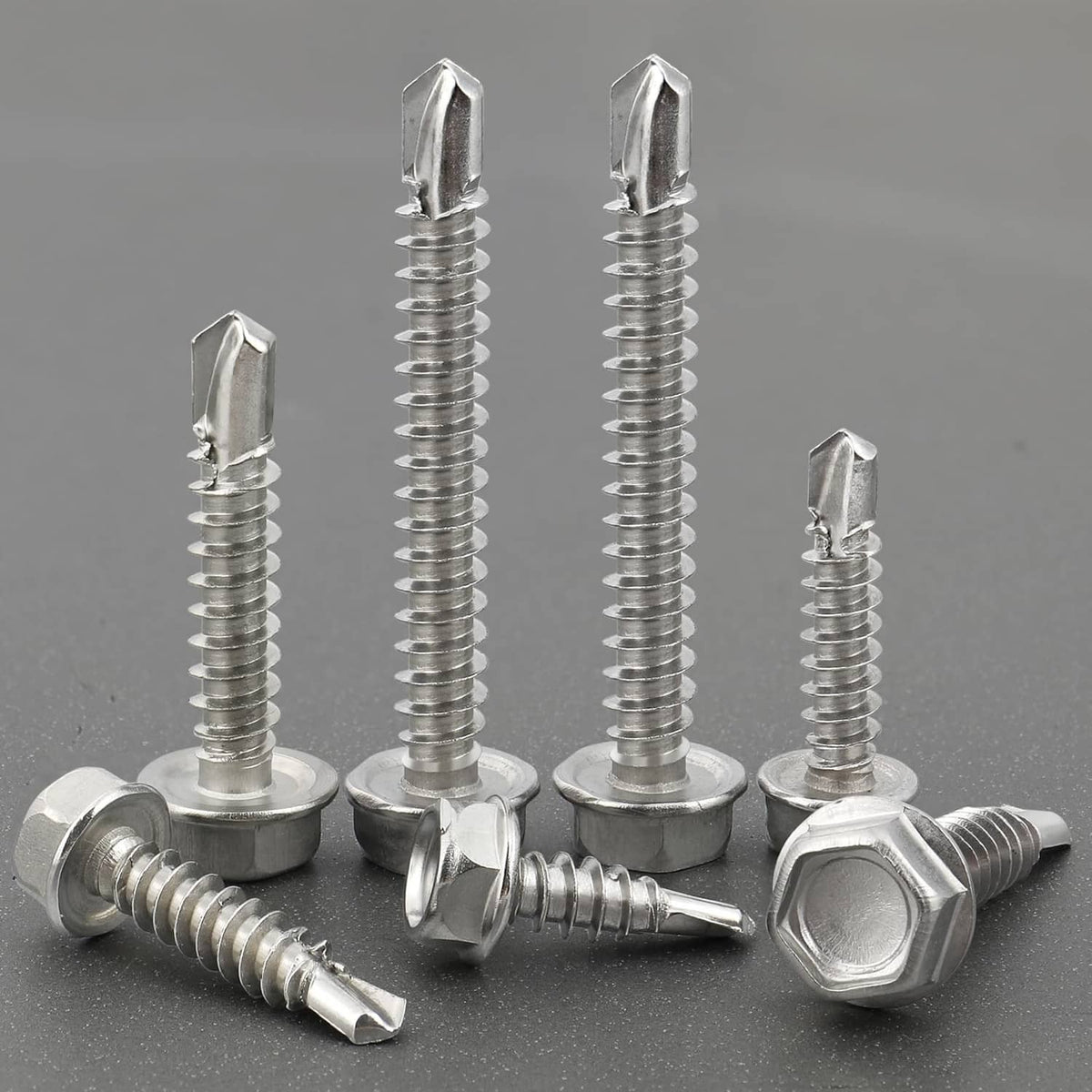 Silver self drilling screws with hex heads and circular washers, close-up set