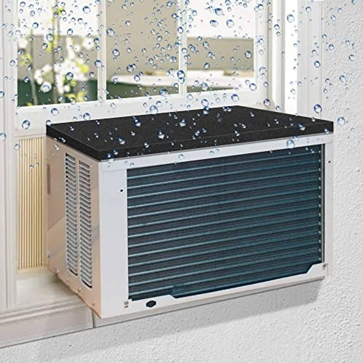 Black AC drip cushion on top of a window air conditioner, fitted over the unit.