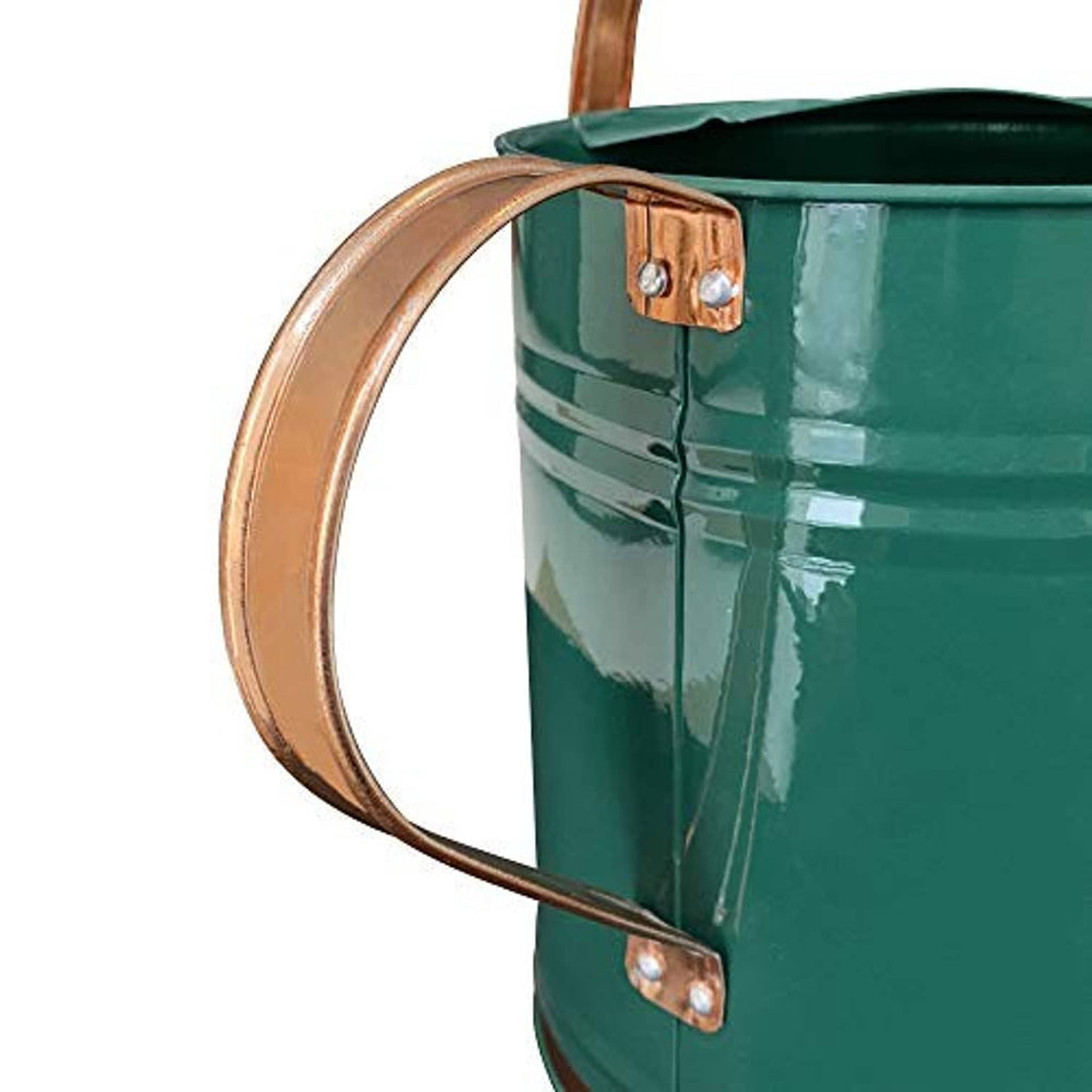 Teal metal watering can close-up with copper-tone handle and side carry bracket
